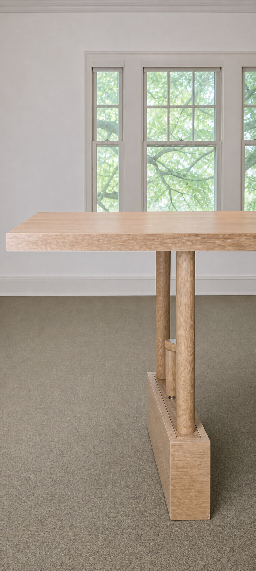 Natural wood TableRaise with its solid-wood top, uprights, and plinth base in a light-filled room
